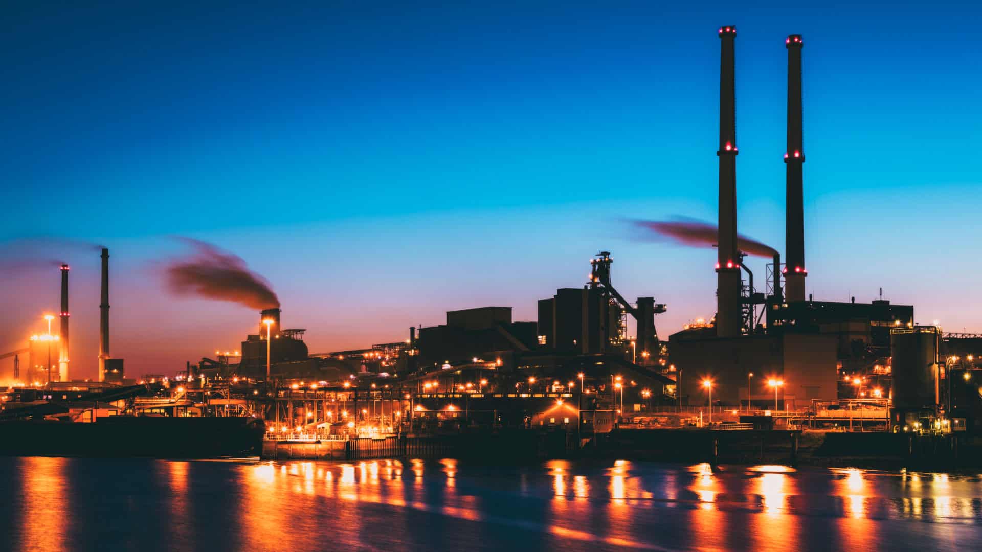 industrial site, early morning, blue sky and icy sea, defending critical infrastructure using threat intelligence